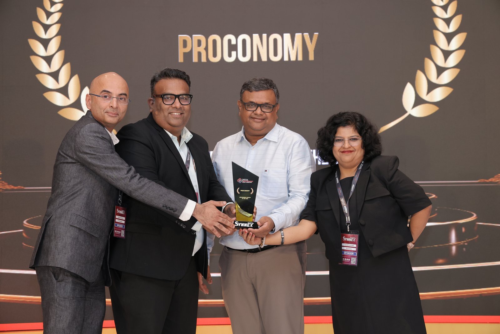 The Proconomy team receiving Procurement Startup of the Year on stage at India Procurement Summit & Awards 2026, the backdrop reading Proconomy