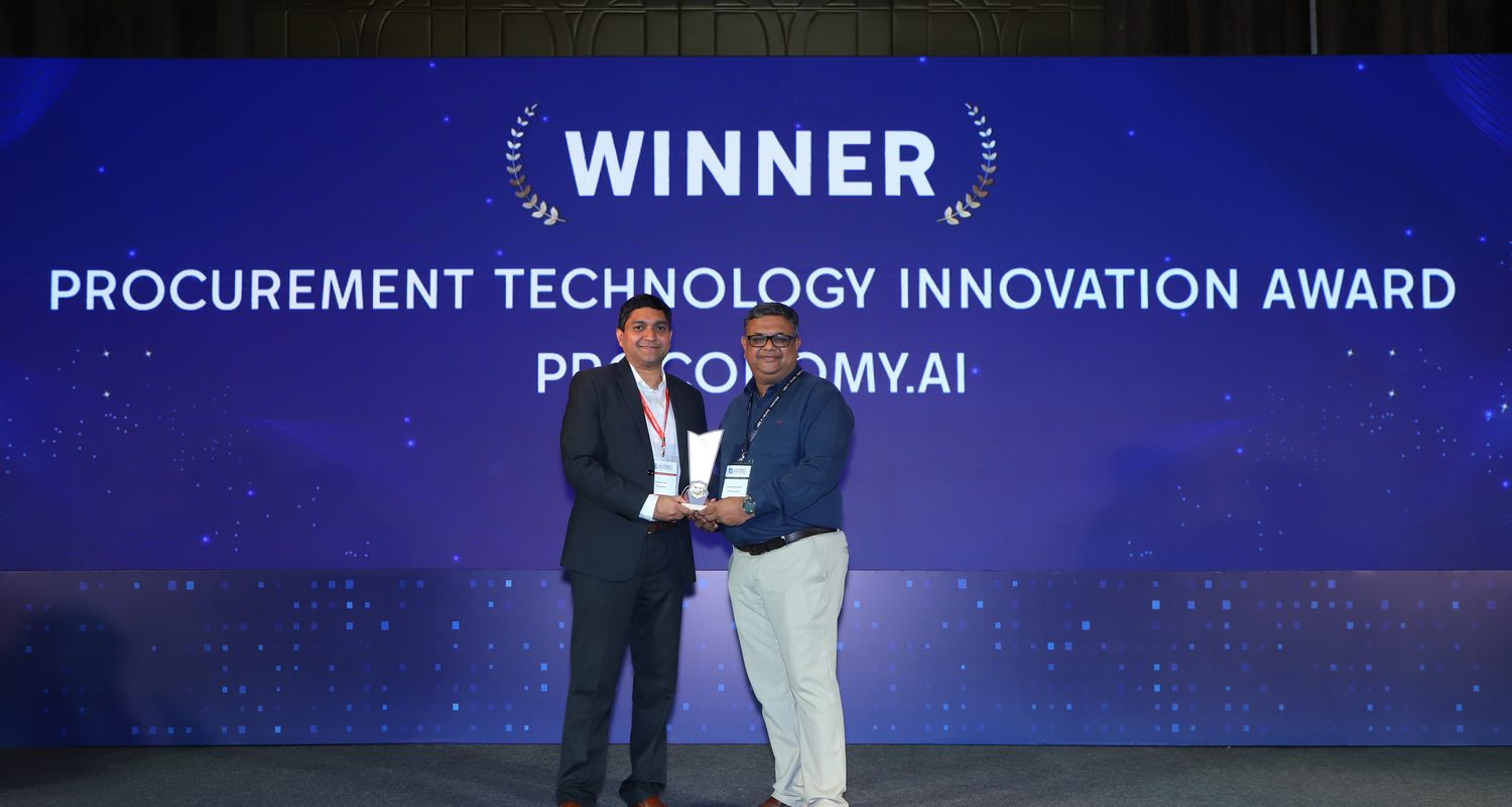 Proconomy receiving Procurement Technology Innovation Award on stage, the summit screen behind reading Winner, Procurement Technology Innovation Award, Proconomy.ai